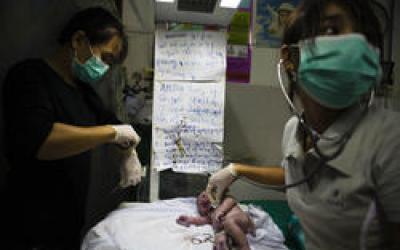 Doctor checking infant vitals